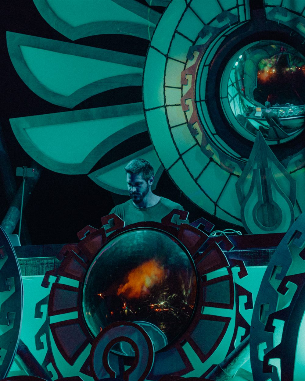 Orecch performing live, framed by stage art